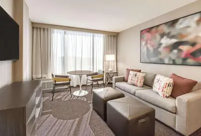 a living room with a couch and a table at Sonesta Denver Downtown in Denver