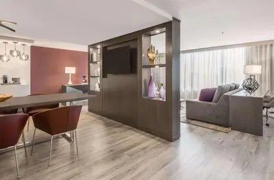 a kitchen and living room with a table and a couch at Sonesta Denver Downtown in Denver