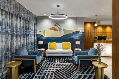 a lobby with two chairs and a couch at Sonesta Denver Downtown in Denver