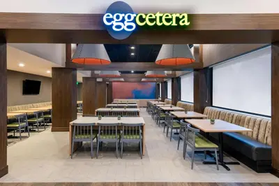 a dining room with tables and chairs in a restaurant at DoubleTree by Hilton Denver Cherry Creek, CO in Denver