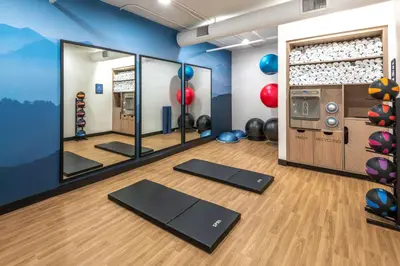a room with a gym with yoga mats and balls at DoubleTree by Hilton Denver Cherry Creek, CO in Denver