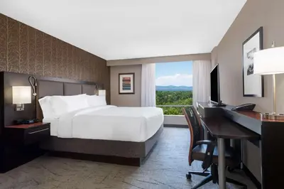 a hotel room with a bed and a desk and a computer at DoubleTree by Hilton Denver Cherry Creek, CO in Denver