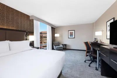 a hotel room with a bed and a desk and a computer at DoubleTree by Hilton Denver Cherry Creek, CO in Denver