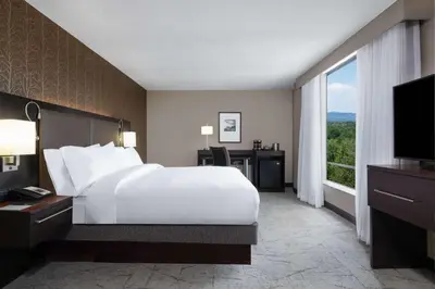 a bedroom with a large white bed and a window at DoubleTree by Hilton Denver Cherry Creek, CO in Denver