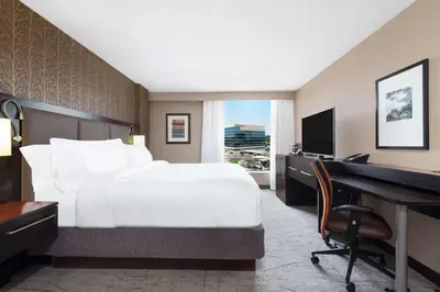 a bedroom with a bed and a desk and a computer at DoubleTree by Hilton Denver Cherry Creek, CO in Denver