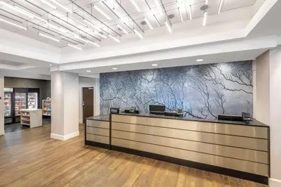 an office lobby with a reception desk with a marble wall at DoubleTree by Hilton Denver Cherry Creek, CO in Denver