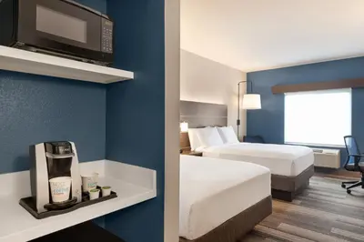a hotel room with two beds and a tv at Holiday Inn Express & Suites Denver Airport by IHG in Denver