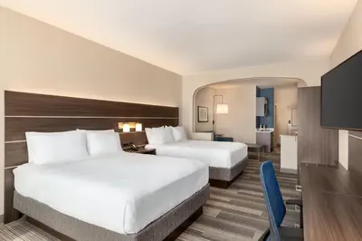 a hotel room with two beds and a television at Holiday Inn Express & Suites Denver Airport by IHG in Denver