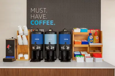 a coffee shop with a bunch of bottles on a counter at Holiday Inn Express & Suites Denver Airport by IHG in Denver