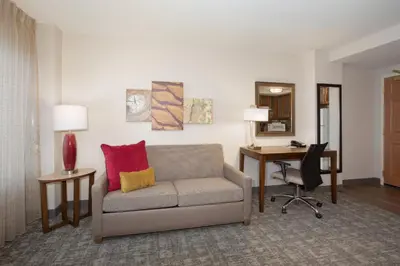 a living room with a couch and a desk at Staybridge Suites Denver International Airport by IHG in Denver