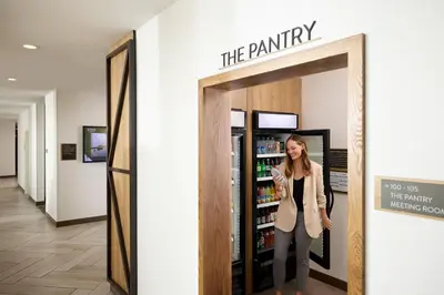 a woman standing in front of the pantry at Staybridge Suites Denver International Airport by IHG in Denver