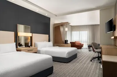 a hotel room with two beds and a desk at Courtyard by Marriott Denver North/Westminster in Eastlake
