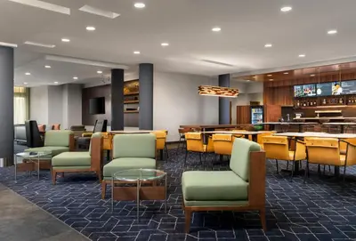 a restaurant with chairs and tables and a bar at Courtyard by Marriott Denver North/Westminster in Eastlake