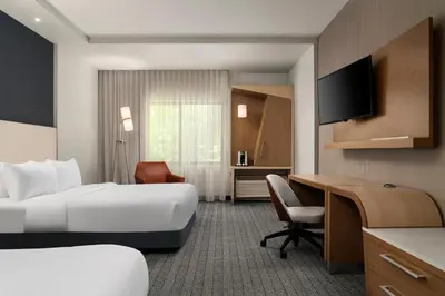 a hotel room with a bed and a desk at Courtyard by Marriott Denver North/Westminster in Eastlake