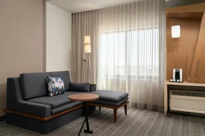 a living room with a couch and a table at Courtyard by Marriott Denver North/Westminster in Eastlake