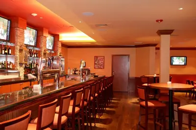 a bar in a restaurant with tables and chairs at Holiday Inn Denver Lakewood by IHG in Lakewood