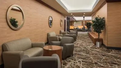 a waiting room with couches and a mirror at Holiday Inn Denver Lakewood by IHG in Lakewood