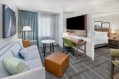 a hotel room with a couch and a bed and a desk at Staybridge Suites Denver - Cherry Creek by IHG in Denver