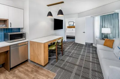a kitchen and living room with a couch and a table at Staybridge Suites Denver - Cherry Creek by IHG in Denver