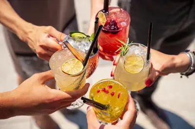a group of people holding up drinks on a table at EVEN Hotels Denver Tech Center-Englewood by IHG in Centennial