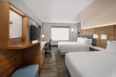 a hotel room with two beds and a desk at EVEN Hotels Denver Tech Center-Englewood by IHG in Centennial