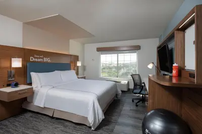 a hotel room with a bed and a desk and a television at EVEN Hotels Denver Tech Center-Englewood by IHG in Centennial