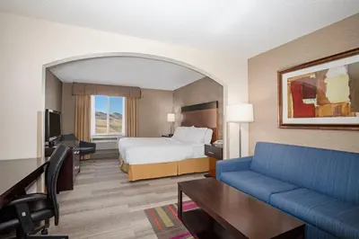 a hotel room with a bed and a couch at Holiday Inn Express Hotel & Suites Littleton by IHG in Littleton