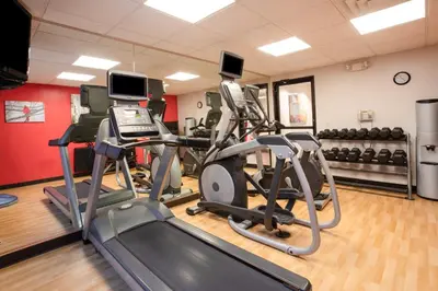 a gym with treadmills and ellipticals in a room at Holiday Inn Express Hotel & Suites Littleton by IHG in Littleton