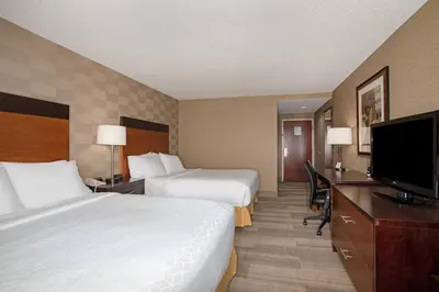 a hotel room with two beds and a flat screen tv at Holiday Inn Express Hotel & Suites Littleton by IHG in Littleton