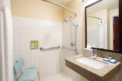 a bathroom with a sink and a mirror at Holiday Inn Express Hotel & Suites Littleton by IHG in Littleton