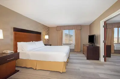 a hotel room with a bed and a flat screen tv at Holiday Inn Express Hotel & Suites Littleton by IHG in Littleton