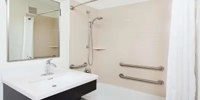 a bathroom with a sink and a shower at Sonesta Simply Suites Denver West Federal Center in Lakewood