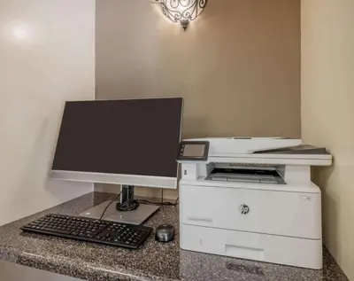 a computer monitor and a printer on a counter at Sonesta Simply Suites Denver West Federal Center in Lakewood