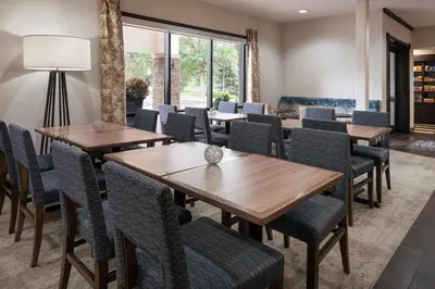 a dining room with wooden tables and chairs at Hampton Inn Loveland in Loveland