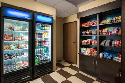 a grocery store aisle with a refrigerator and lots of food at Hampton Inn Loveland in Loveland