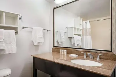 a bathroom with a sink and a mirror at Hampton Inn Loveland in Loveland