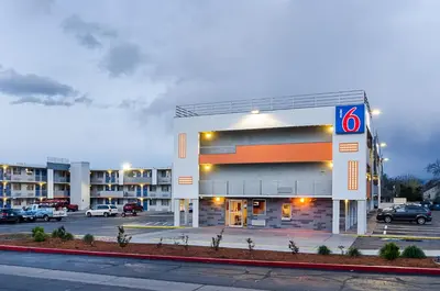 a building with a number sign in a parking lot at Motel 6- Denver, CO Downtown in Denver