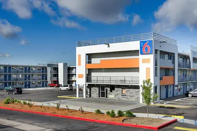 a building with a parking lot in front of it at Motel 6- Denver, CO Downtown in Denver