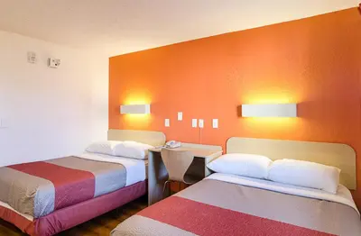 a hotel room with two beds and a desk at Motel 6- Denver, CO Downtown in Denver