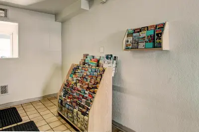 a display of books on a shelf in a room at Motel 6-Denver, CO - Airport in Denver