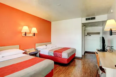 a hotel room with two beds and a television at Motel 6-Denver, CO - Airport in Denver