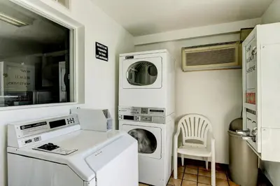 a laundry room with a washer and dryer at Motel 6-Denver, CO - Airport in Denver