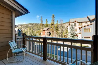 a balcony with a chair and a view of the water at Keystone Private Homes by Vail Resorts in Keystone