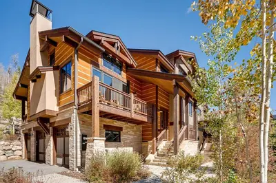 a log home with a balcony and stairs to it at Keystone Private Homes by Vail Resorts in Keystone