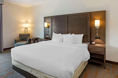 a large white bed in a hotel room at Comfort Inn & Suites Brighton Denver NE Medical Center in Brighton