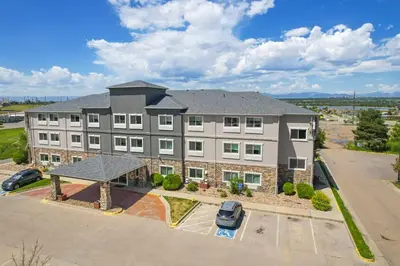 an aerial view of a large building with a parking lot at Baymont by Wyndham Henderson-Northeast Denver in Henderson