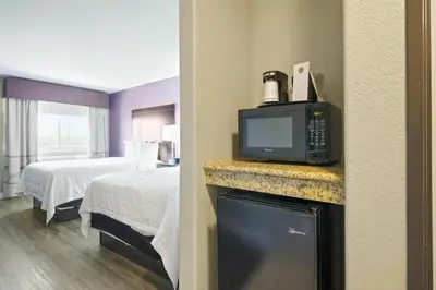 a hotel room with a bed and a tv at Baymont by Wyndham Henderson-Northeast Denver in Henderson