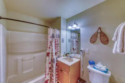 a bathroom with a sink and a toilet and a shower at Hidden River Lodge 5975 in Keystone