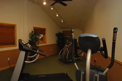 a gym with cardio equipment in a room at Hidden River Lodge 5975 in Keystone