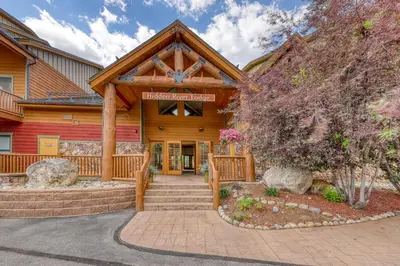 a log home with a staircase leading to the front door at Hidden River Lodge 5975 in Keystone